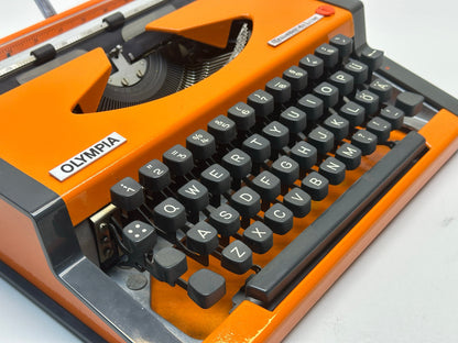 Olympia Orange Typewriter - Vibrant Typing Experience with Matching Orange Bag, 1960 Model, QWERTY Layout - An Antique Typewriter Gem