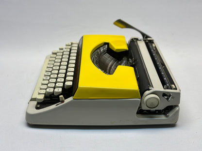 Discover Vintage Splendor with the Yellow Olympia Deluxe Typewriter - German-Made, Antique Treasure